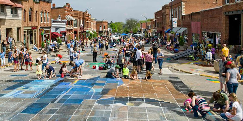 Chalk the Walk 2015 photo of the street and participants working on the collaborative piece of art, Grant Wood's "American Gothic"