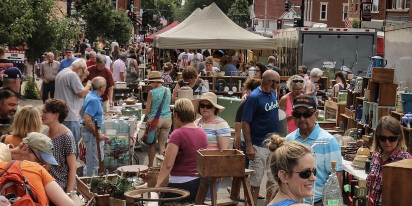 huge crowd of people outdoors on main street at the Nitty Gritty antique festival