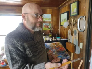 a person painting at an easel