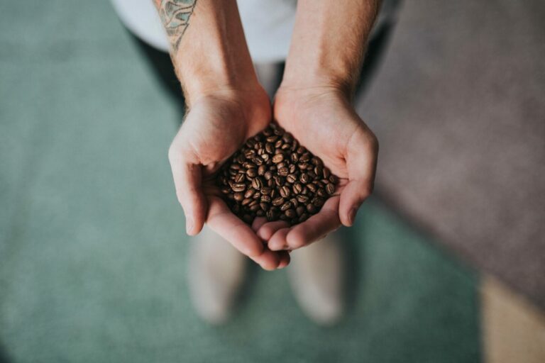 coffee beans in hands large.1 768x512