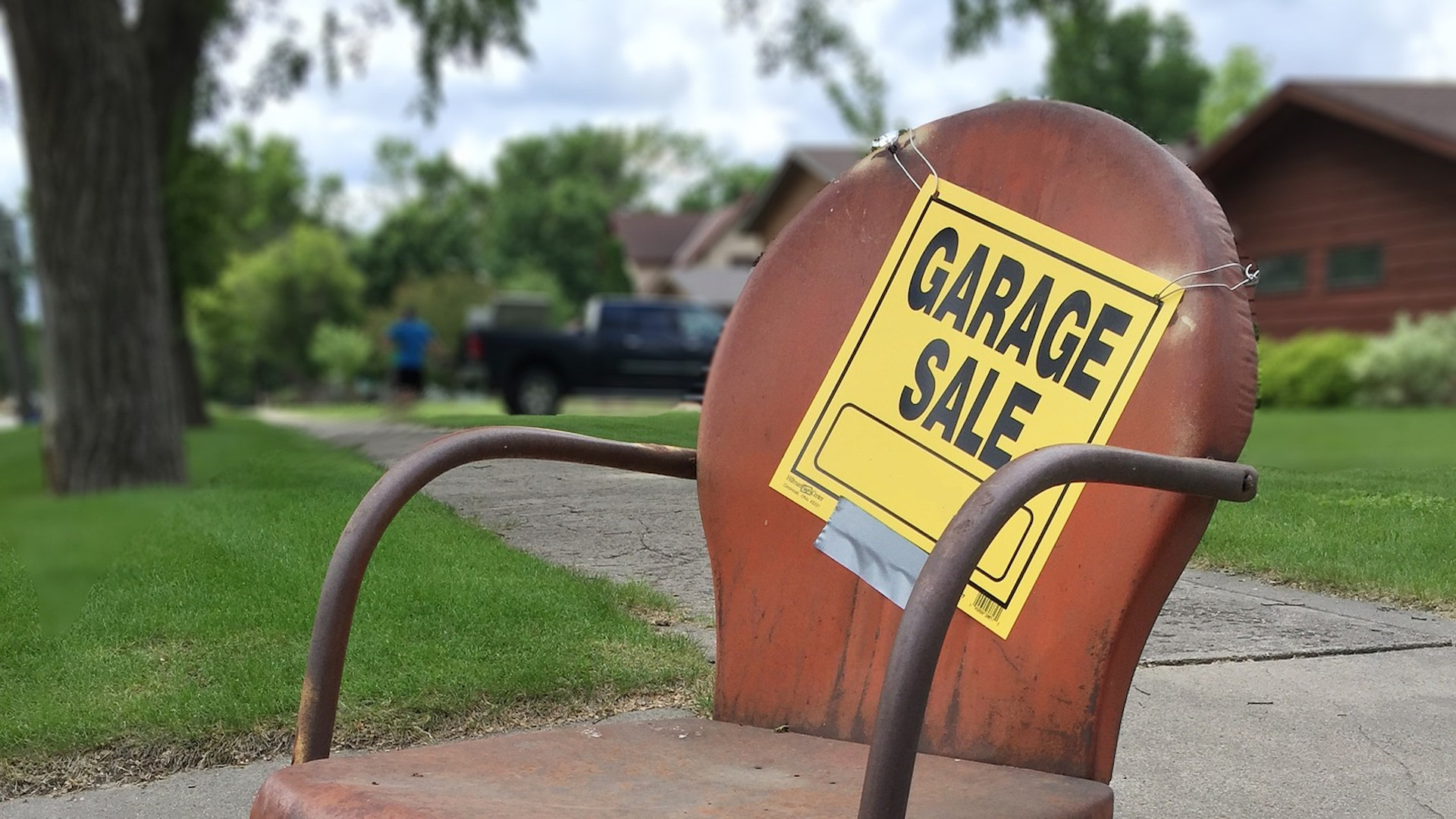 Garage Sale sign taped to an old office chair