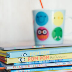 Stack of story books with under a cup
