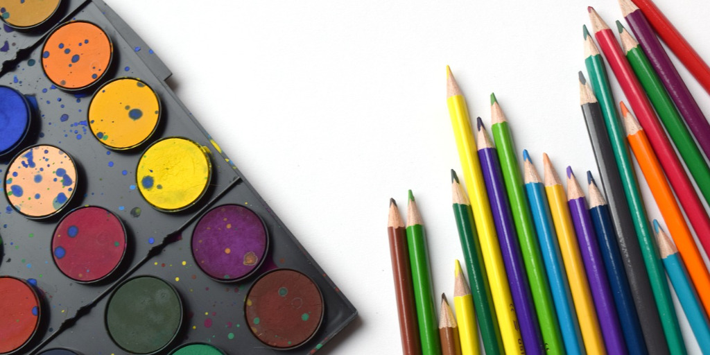 Colorful paints and colored pencils