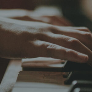 Close up of hands playing piano