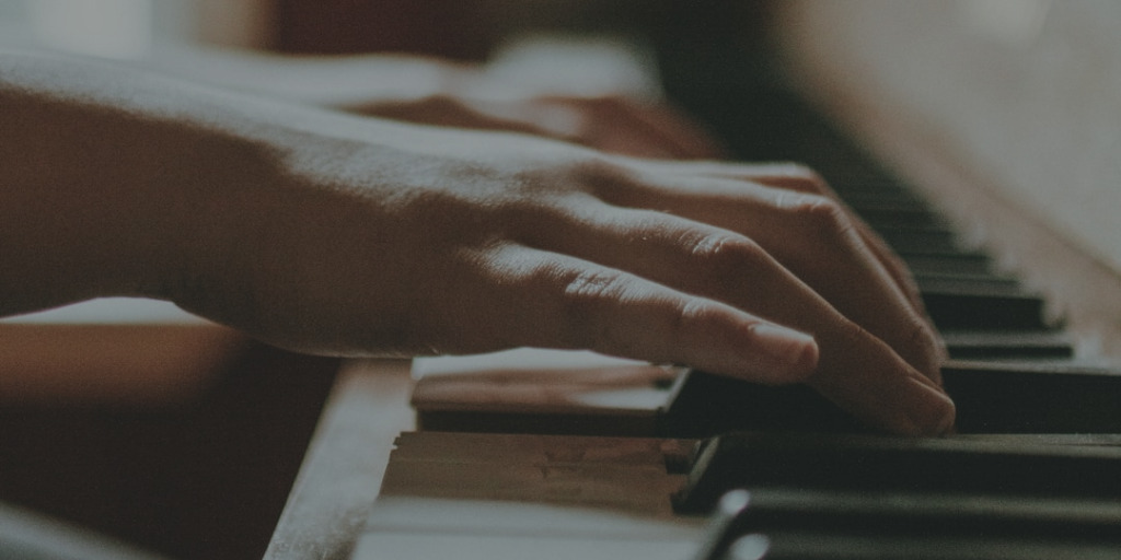 Close up of hands playing piano