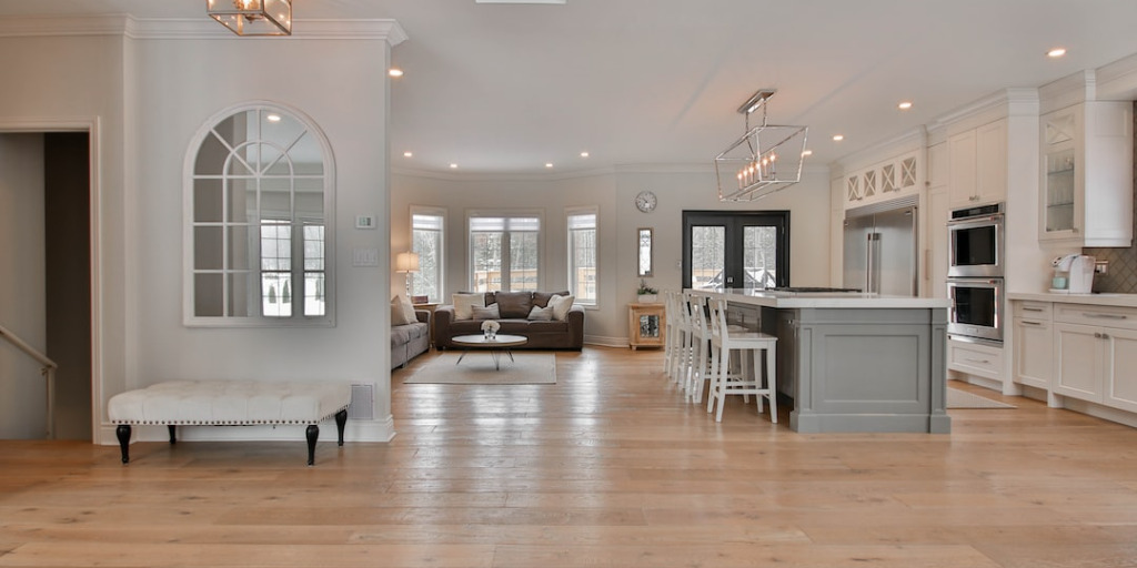 Home displaying hardwood flooring, lighting, kitchen, and decor