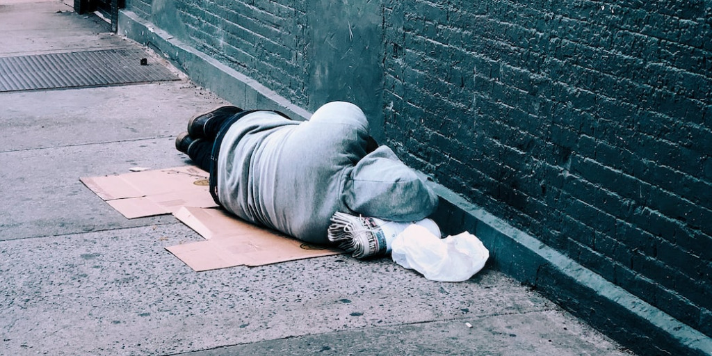 Homeless person sleeping in an ally