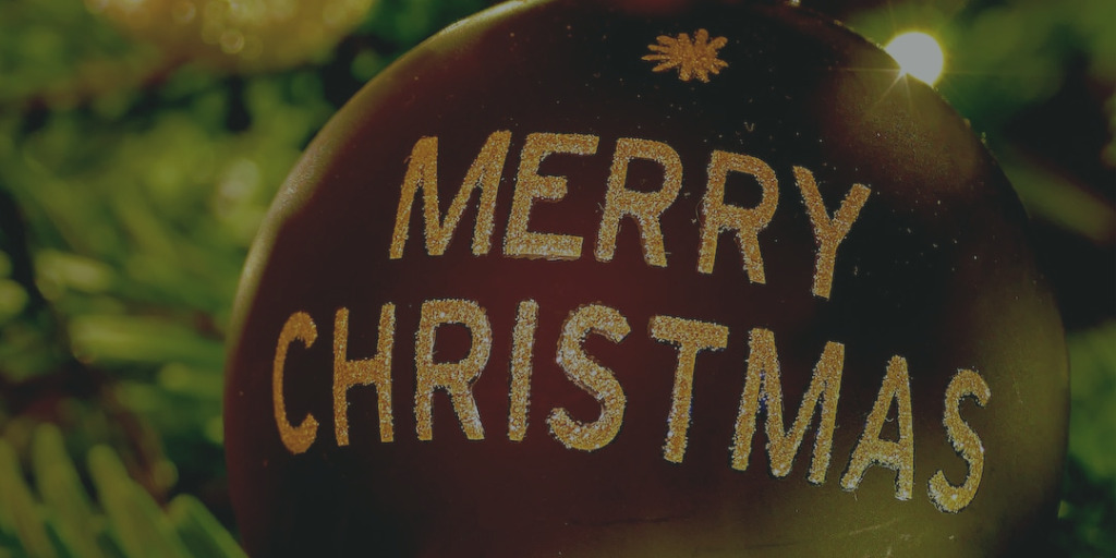 Merry Christmas in white text on red ornament
