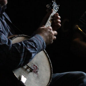 A couple people playing Irish musical instruments